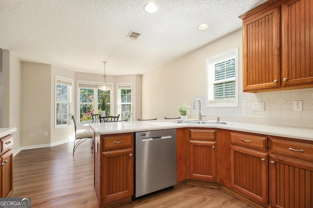 286 Prominent Loop, Mcdonough, GA 30253 - kitchen featuring dishwasher, light wood finished floors, light countertops, a peninsula, and tasteful backsplash