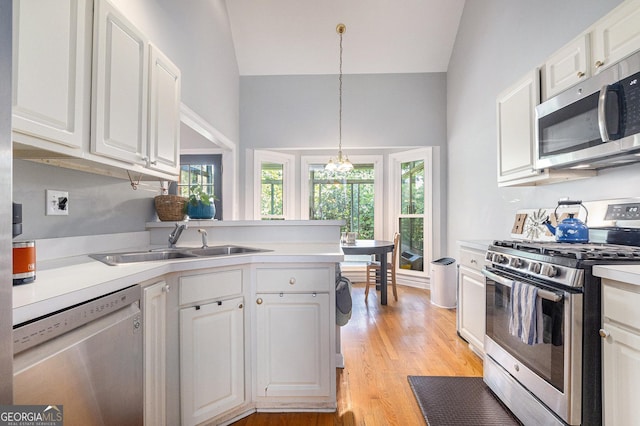 1469 Crescent Walk, Decatur, GA 30033 - kitchen featuring appliances with stainless steel finishes, white cabinetry, light countertops, and vaulted ceiling