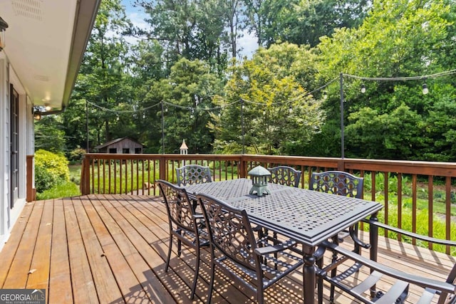 2628 Tanglewood Rd, Decatur, GA 30033 - wooden terrace with outdoor dining space, an outbuilding, and view of scattered trees