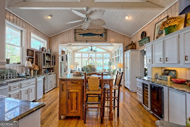 165 Pepe Rd, Clayton, GA 30525 - kitchen featuring a ceiling fan, lofted ceiling, light wood-style floors, wood walls, and wine cooler