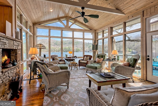 165 Pepe Rd, Clayton, GA 30525 - living room with a stone fireplace, high vaulted ceiling, a ceiling fan, a water view, and a wooden ceiling with exposed beams