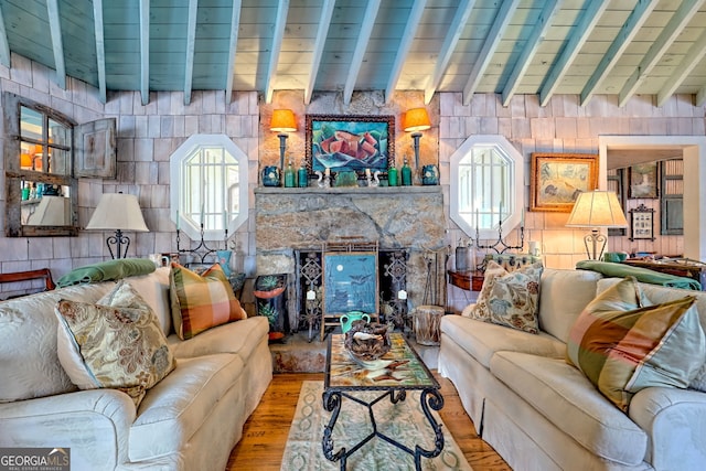 165 Pepe Rd, Clayton, GA 30525 - living area featuring wood finished floors, a stone fireplace, and beamed ceiling