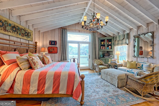 165 Pepe Rd, Clayton, GA 30525 - bedroom featuring a chandelier, wood-type flooring, multiple windows, access to exterior, and wood walls