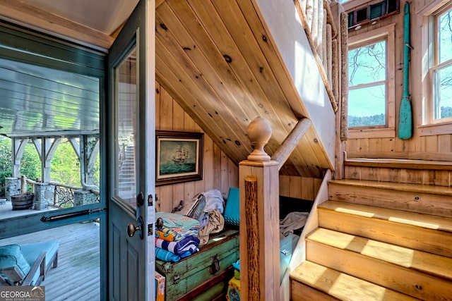165 Pepe Rd, Clayton, GA 30525 - staircase with wood walls, vaulted ceiling, healthy amount of natural light, and wood finished floors