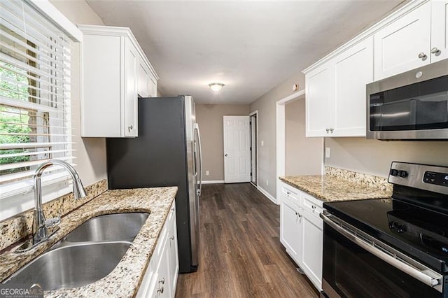 4009 Kirksford Dr, Decatur, GA 30035 - kitchen with stainless steel appliances, white cabinetry, dark wood-style flooring, and light stone counters