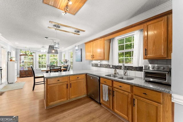 15 Miners Pt SE, Acworth, GA 30102 - kitchen with dishwasher, ornamental molding, a peninsula, light wood-style flooring, and brown cabinets
