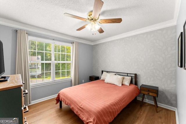 15 Miners Pt SE, Acworth, GA 30102 - bedroom with light wood-style floors, crown molding, a textured ceiling, a ceiling fan, and wallpapered walls