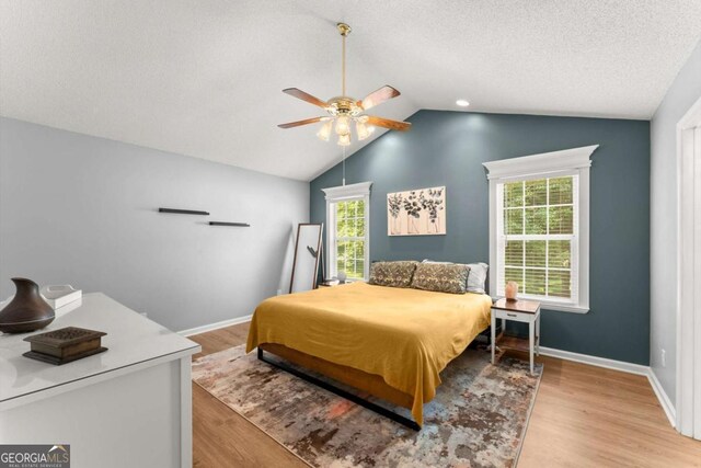 15 Miners Pt SE, Acworth, GA 30102 - bedroom featuring wood finished floors, vaulted ceiling, ceiling fan, and a textured ceiling