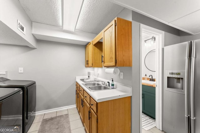 15 Miners Pt SE, Acworth, GA 30102 - kitchen with stainless steel fridge, washing machine and clothes dryer, light countertops, and light tile patterned floors