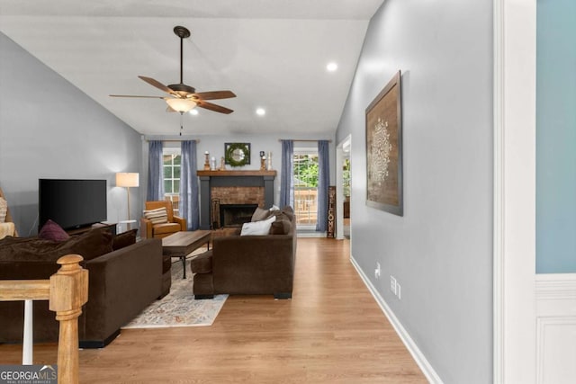 15 Miners Pt SE, Acworth, GA 30102 - living area with vaulted ceiling, ceiling fan, a brick fireplace, light wood-style floors, and recessed lighting
