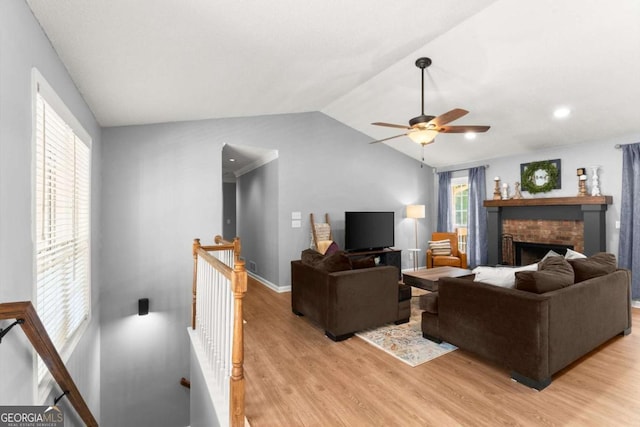 15 Miners Pt SE, Acworth, GA 30102 - living area with light wood finished floors, ceiling fan, lofted ceiling, and a brick fireplace