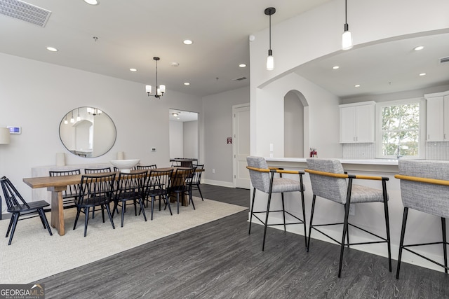 1512 Big Bud Ln, Locust Grove, GA 30248 - kitchen featuring recessed lighting, dark wood-style floors, a kitchen breakfast bar, white cabinetry, and pendant lighting
