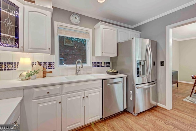 1693 Alderbrook Rd NE, Atlanta, GA 30345 - kitchen with stainless steel appliances, white cabinets, light wood-style flooring, ornamental molding, and backsplash