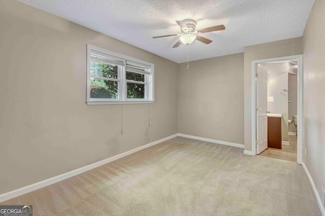 1693 Alderbrook Rd NE, Atlanta, GA 30345 - unfurnished bedroom with carpet, a textured ceiling, a ceiling fan, and ensuite bathroom