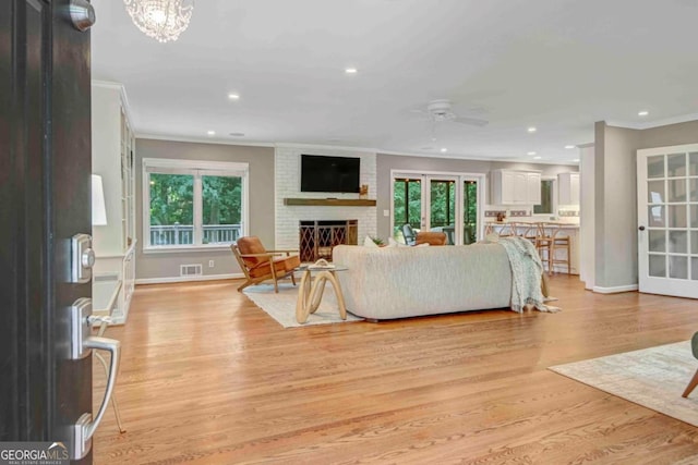 1693 Alderbrook Rd NE, Atlanta, GA 30345 - living room with ornamental molding, a ceiling fan, light wood-style floors, healthy amount of natural light, and recessed lighting