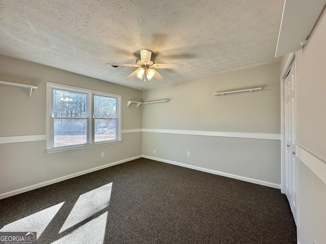 4035 Winchester Way, Loganville, GA 30052 - spare room featuring dark carpet, a ceiling fan, and a textured ceiling
