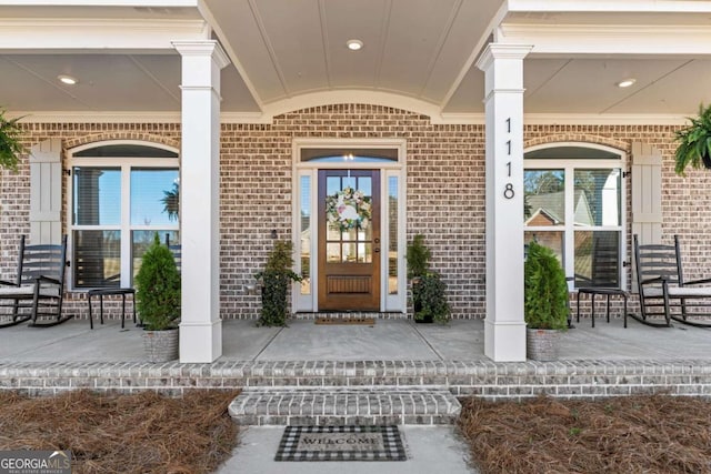 1118 Coralbell Dr, Statham, GA 30666 - property entrance featuring a porch and brick siding