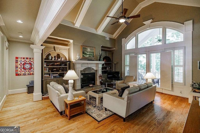 2052 Trimleston Rd, Statham, GA 30666 - living room with ceiling fan, wood finished floors, a premium fireplace, high vaulted ceiling, and built in shelves