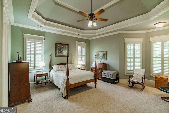 2052 Trimleston Rd, Statham, GA 30666 - carpeted bedroom featuring a raised ceiling, multiple windows, crown molding, and a ceiling fan