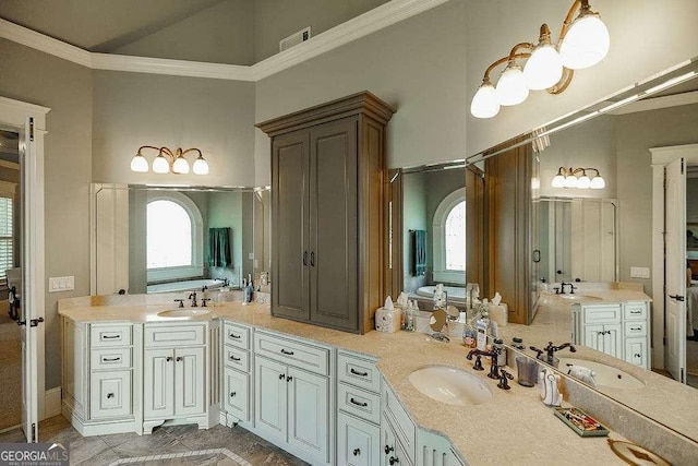 2052 Trimleston Rd, Statham, GA 30666 - bathroom featuring a high ceiling, double vanity, and ornamental molding