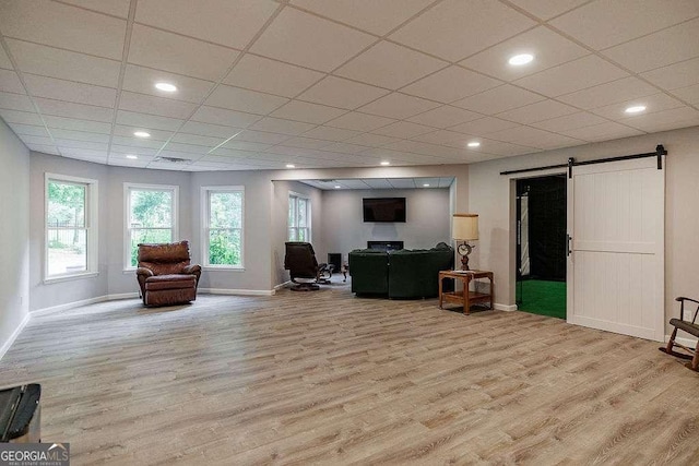 2052 Trimleston Rd, Statham, GA 30666 - living room with wood finished floors, a barn door, a drop ceiling, and recessed lighting