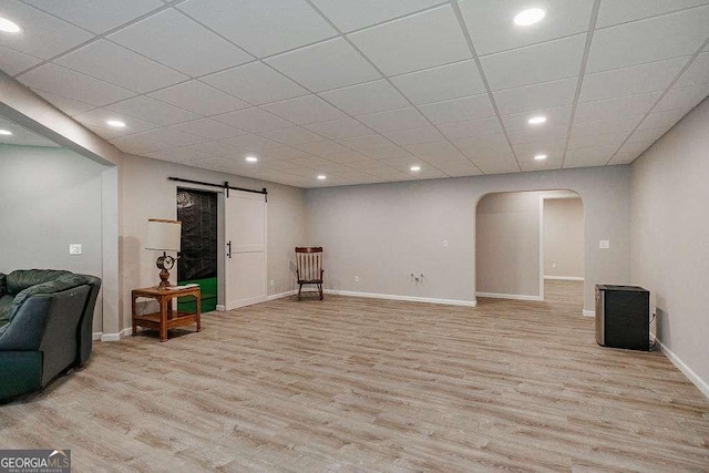 2052 Trimleston Rd, Statham, GA 30666 - sitting room with arched walkways, light wood-style flooring, a barn door, recessed lighting, and a paneled ceiling