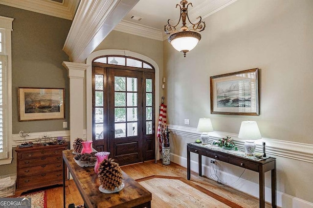 2052 Trimleston Rd, Statham, GA 30666 - foyer entrance featuring light wood-style floors, ornamental molding, healthy amount of natural light, and wainscoting