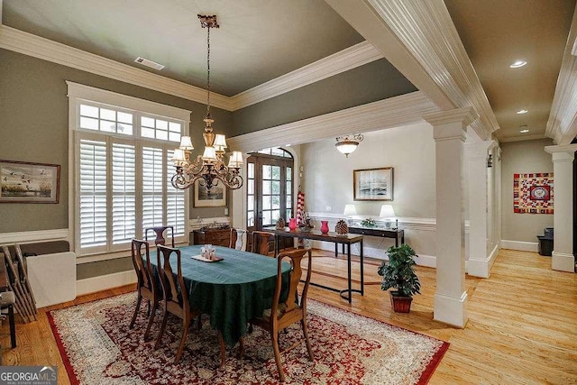 2052 Trimleston Rd, Statham, GA 30666 - dining area featuring decorative columns, ornamental molding, wood finished floors, and a chandelier