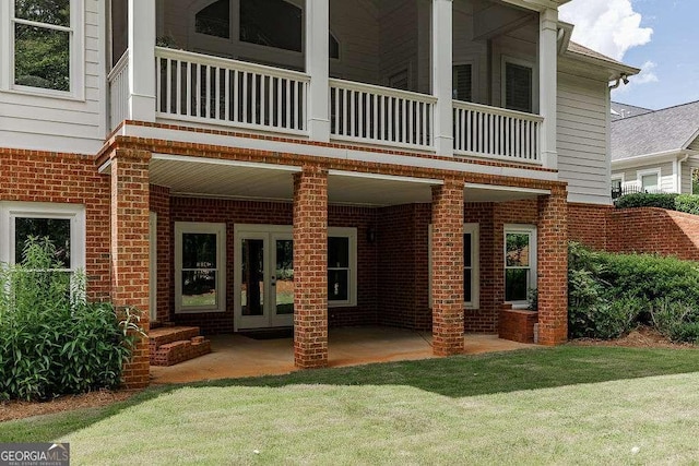 2052 Trimleston Rd, Statham, GA 30666 - view of exterior entry with french doors, a yard, brick siding, and a balcony