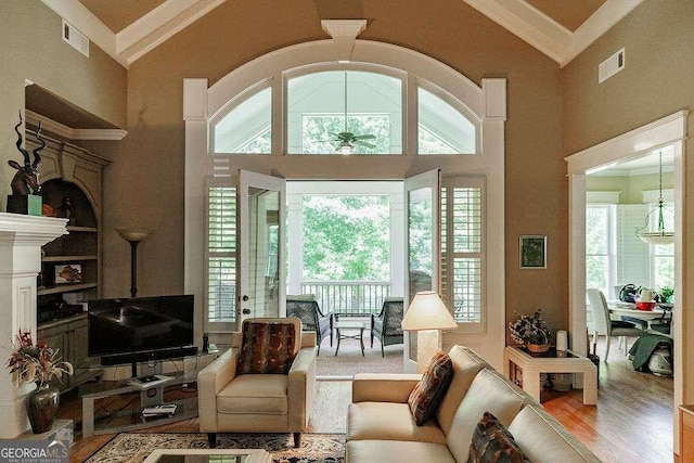 2052 Trimleston Rd, Statham, GA 30666 - living area featuring wood finished floors, ceiling fan, healthy amount of natural light, and high vaulted ceiling