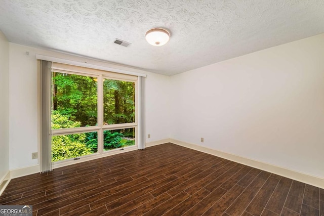 1690 Trotters Ln, Stone Mountain, GA 30087 - empty room with a textured ceiling and dark wood finished floors