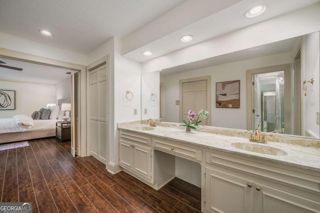 1690 Trotters Ln, Stone Mountain, GA 30087 - ensuite bathroom featuring double vanity, wood finished floors, and recessed lighting