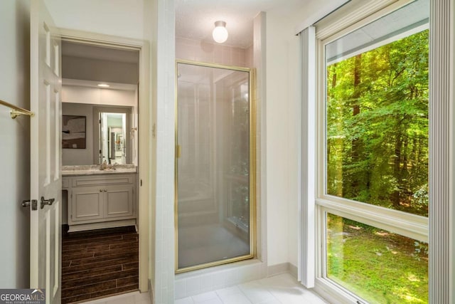 1690 Trotters Ln, Stone Mountain, GA 30087 - bathroom with vanity, a shower stall, and tile patterned flooring