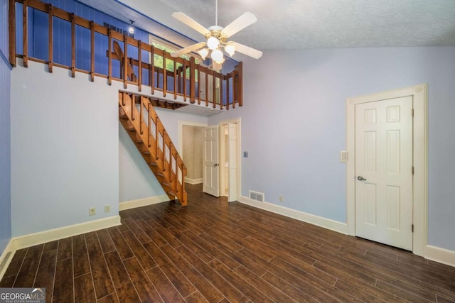 1690 Trotters Ln, Stone Mountain, GA 30087 - unfurnished living room with a ceiling fan, stairs, wood finished floors, and high vaulted ceiling