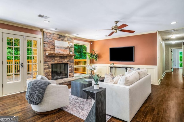 1690 Trotters Ln, Stone Mountain, GA 30087 - living area featuring crown molding, plenty of natural light, a wainscoted wall, dark wood-style floors, and a fireplace