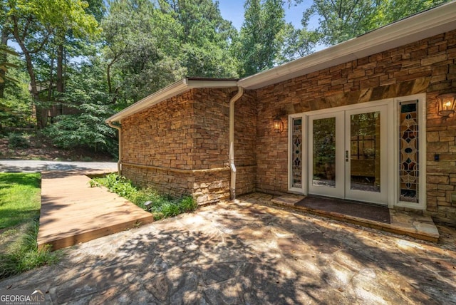 1690 Trotters Ln, Stone Mountain, GA 30087 - entrance to property featuring french doors, stone siding, and a patio