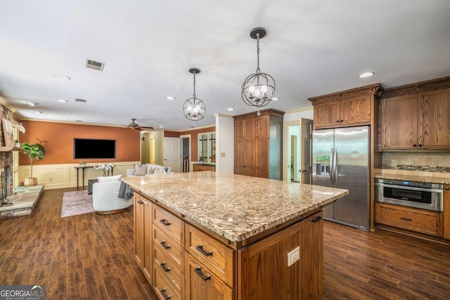 1690 Trotters Ln, Stone Mountain, GA 30087 - kitchen featuring appliances with stainless steel finishes, dark wood-style floors, a ceiling fan, a kitchen island, and recessed lighting