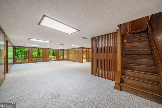 1690 Trotters Ln, Stone Mountain, GA 30087 - below grade area with carpet floors, a textured ceiling, and wooden walls