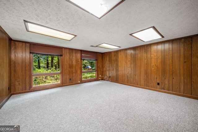 1690 Trotters Ln, Stone Mountain, GA 30087 - empty room with a textured ceiling, carpet, and wooden walls
