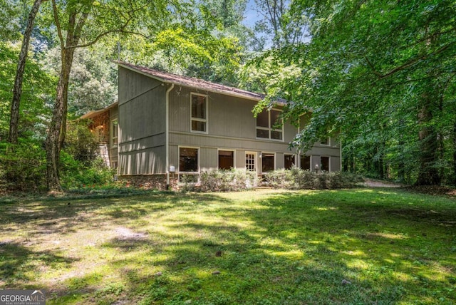 1690 Trotters Ln, Stone Mountain, GA 30087 - rear view of property featuring a yard