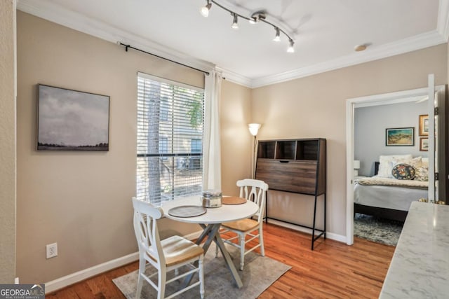 3777 Peachtree Rd NE Unit 1216, Atlanta, GA 30319 - dining area with crown molding, wood finished floors, and track lighting
