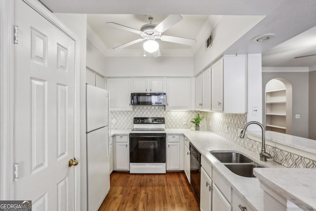 3777 Peachtree Rd NE Unit 1216, Atlanta, GA 30319 - kitchen with black appliances, crown molding, ceiling fan, white cabinetry, and decorative backsplash