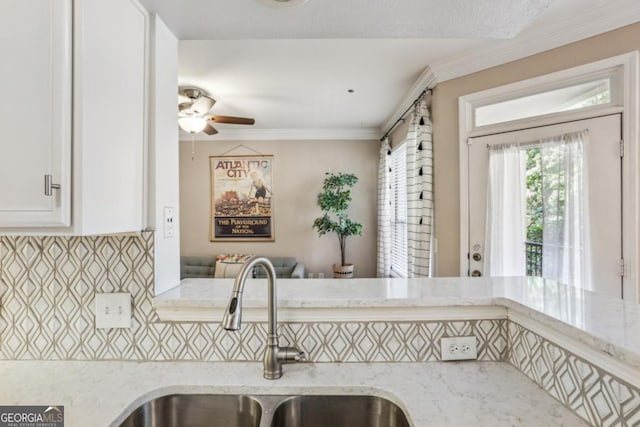 3777 Peachtree Rd NE Unit 1216, Atlanta, GA 30319 - kitchen featuring a ceiling fan, light stone countertops, white cabinetry, ornamental molding, and tasteful backsplash