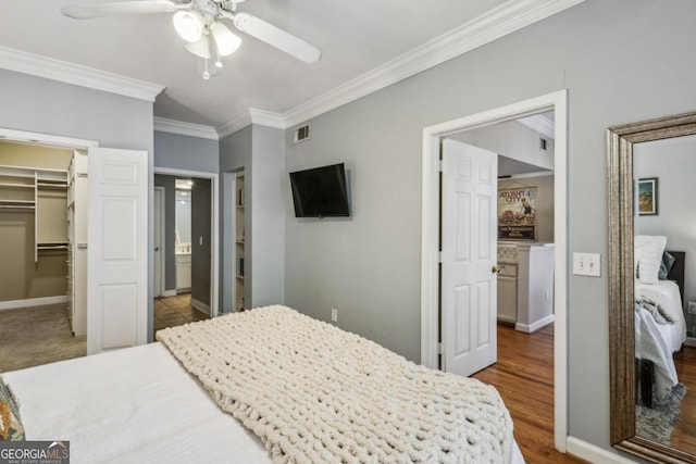 3777 Peachtree Rd NE Unit 1216, Atlanta, GA 30319 - bedroom with ornamental molding, a spacious closet, wood finished floors, a closet, and ceiling fan