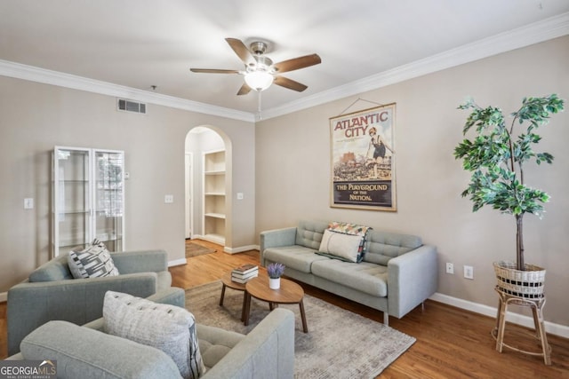 3777 Peachtree Rd NE Unit 1216, Atlanta, GA 30319 - living room with arched walkways, a ceiling fan, wood finished floors, and crown molding