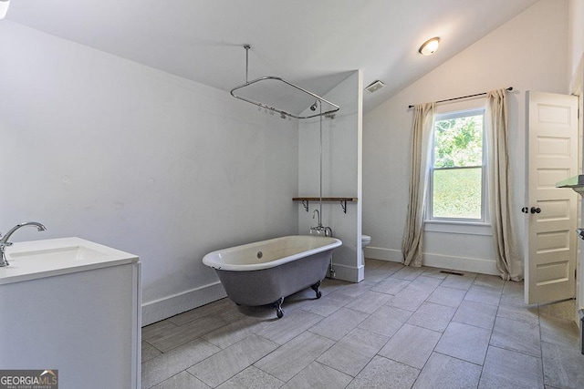 242 Hydrolia, Macon, GA 31217 - bathroom featuring a freestanding tub, vaulted ceiling, and vanity