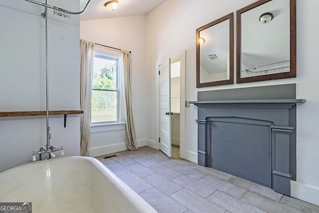 242 Hydrolia, Macon, GA 31217 - bathroom featuring a freestanding bath and baseboards