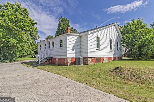 242 Hydrolia, Macon, GA 31217 - view of property exterior with crawl space, a yard, and a chimney
