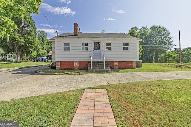 242 Hydrolia, Macon, GA 31217 - rear view of property with a yard, entry steps, and a chimney
