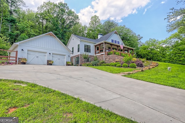 533 Ledford Rd, Dillard, GA 30537 - view of front facade with a front lawn, a chimney, an outbuilding, a detached garage, and board and batten siding